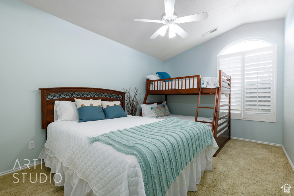 Bedroom with visible vents, baseboards, a ceiling fan, carpet, and lofted ceiling