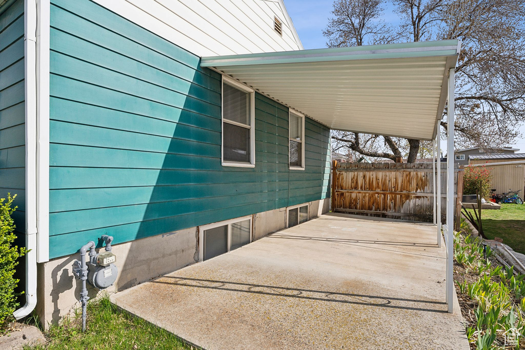 View of patio / terrace with an attached carport and fence