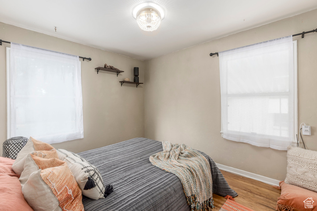Bedroom with wood finished floors and baseboards