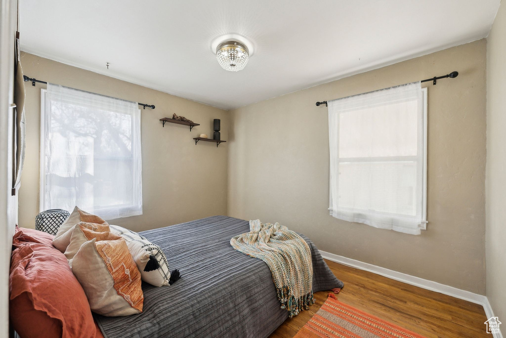 Bedroom featuring baseboards and wood finished floors