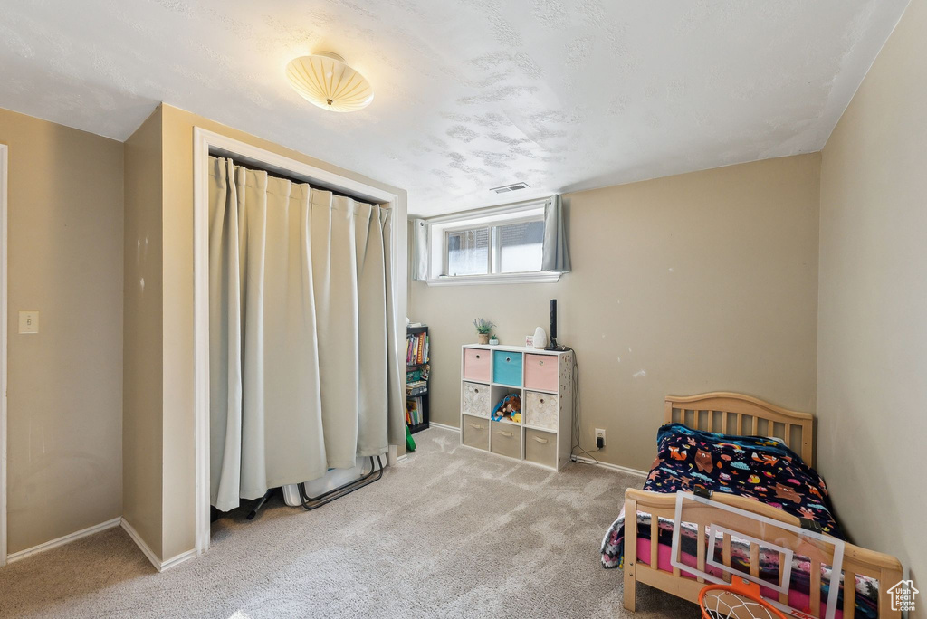 Bedroom featuring carpet floors, baseboards, and visible vents