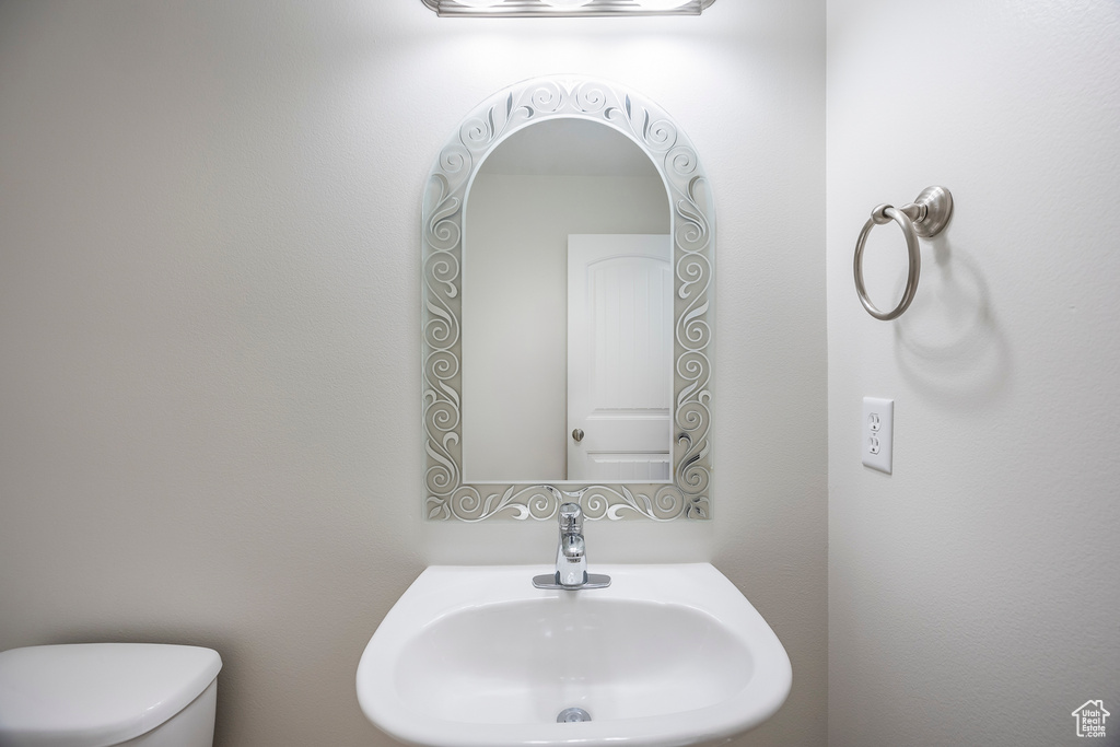 Half bathroom featuring a sink and toilet