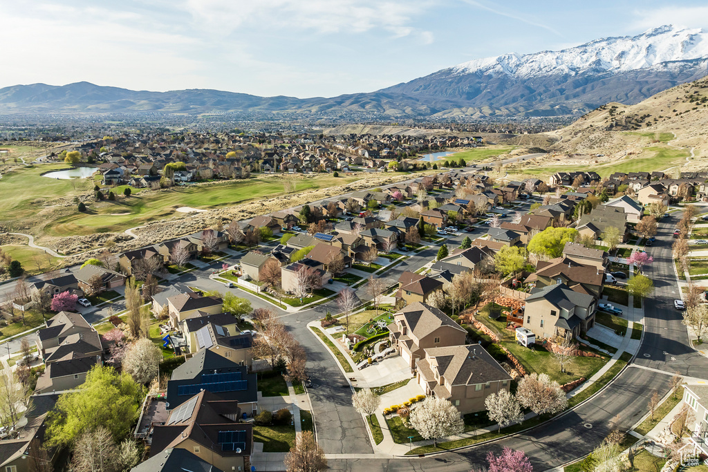 Birds eye view of property featuring view of golf course, a water and mountain view, and a residential view