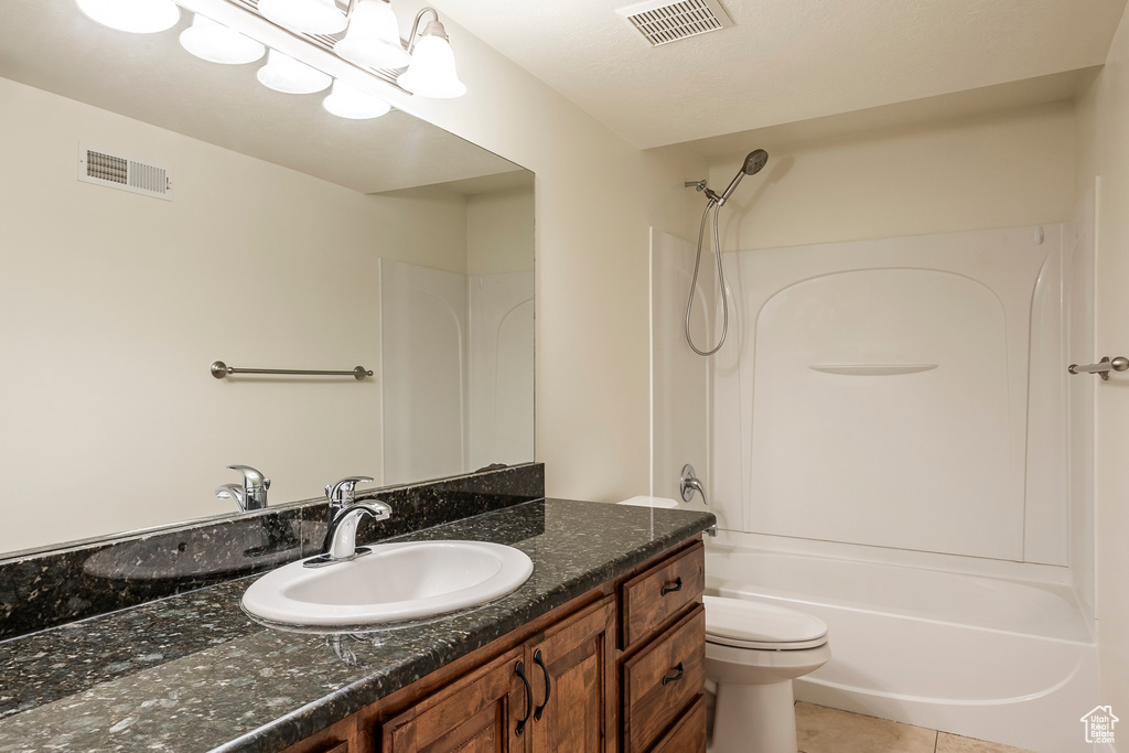 Bathroom featuring visible vents, toilet, shower / bathing tub combination, and vanity