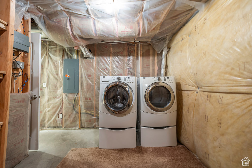 Washroom with laundry area, washing machine and clothes dryer, and electric panel