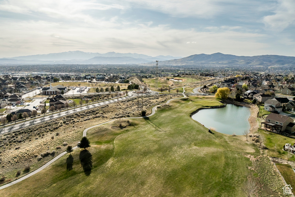 Birds eye view of property featuring a water and mountain view