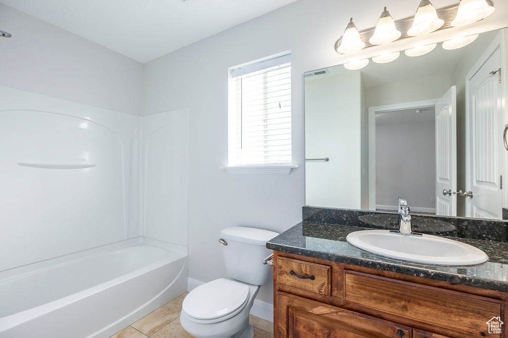 Full bath featuring visible vents, baseboards, toilet, vanity, and tile patterned floors