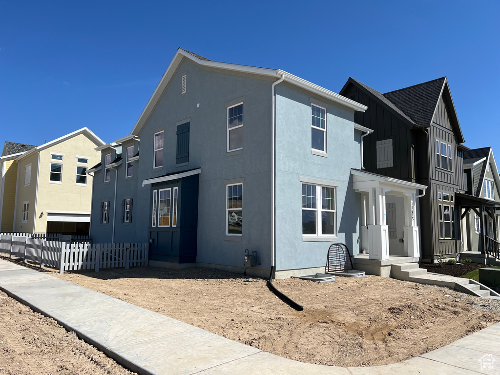 Multi unit property featuring stucco siding and fence
