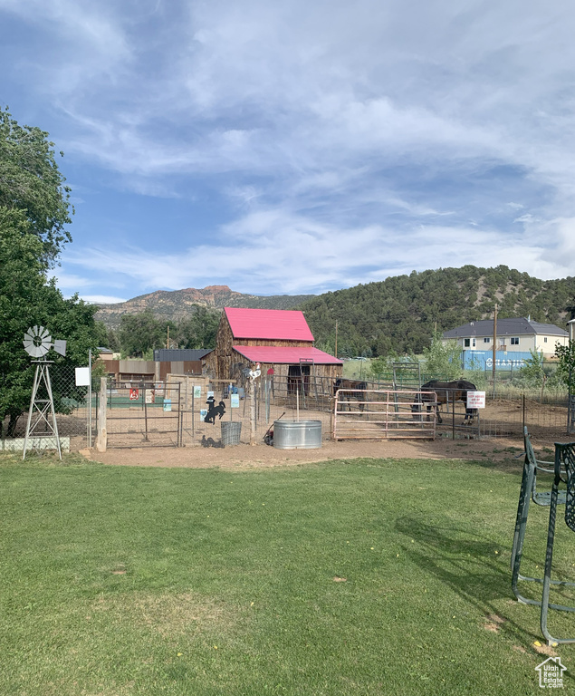View of yard featuring a mountain view and an outdoor structure