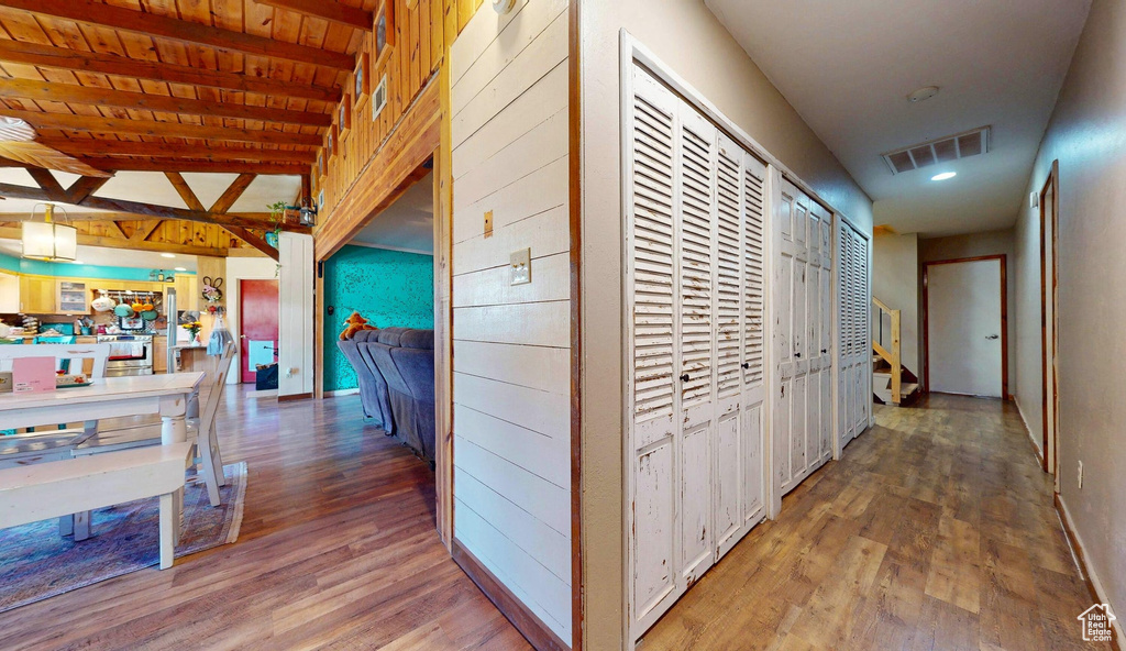 Hallway featuring wood finished floors and beam ceiling