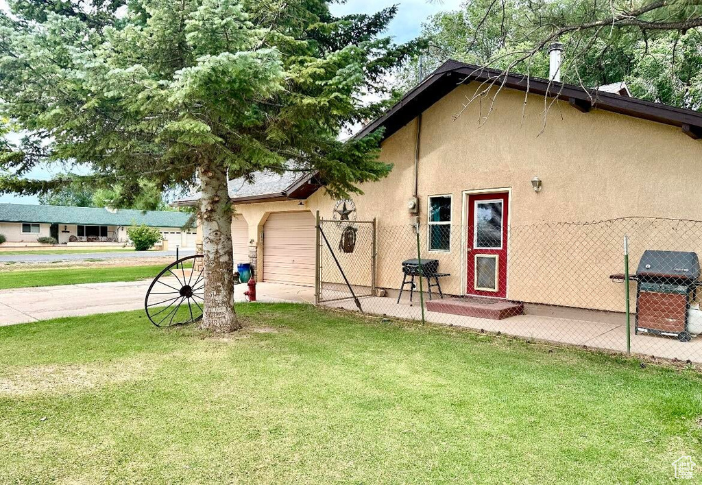 View of side of home featuring stucco siding and an attached garage