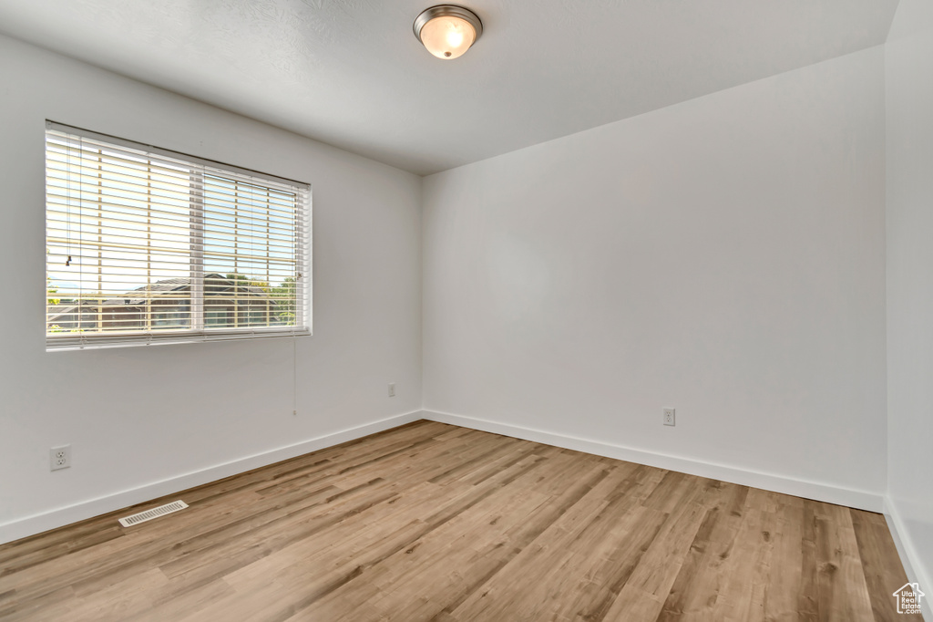 Empty room with baseboards and wood finished floors