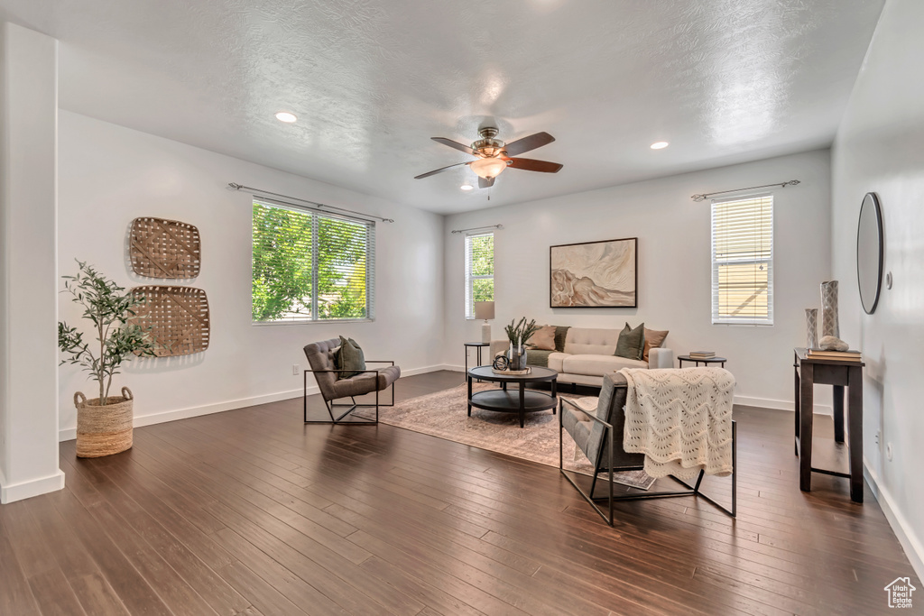 Living room featuring ceiling fan, recessed lighting, dark wood-style flooring, baseboards, and a textured ceiling