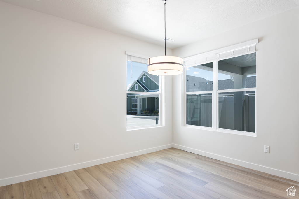 Unfurnished room with wood finished floors and baseboards