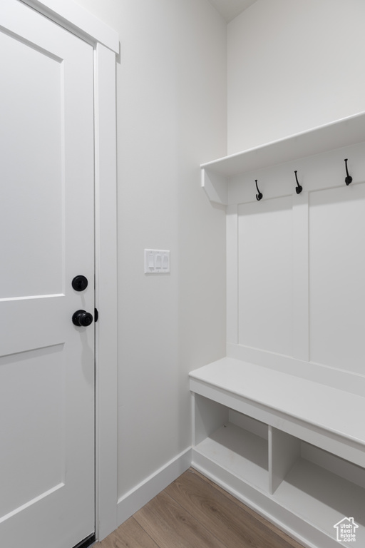 Mudroom with wood finished floors and baseboards