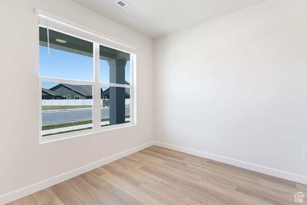 Spare room with light wood-style flooring and baseboards
