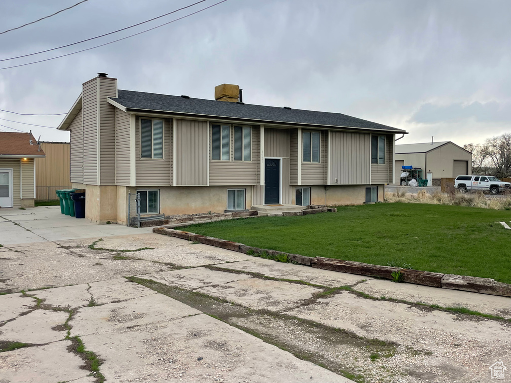 Exterior space featuring a front yard and a chimney