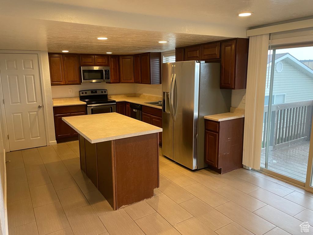 Kitchen featuring a sink, recessed lighting, light countertops, and stainless steel appliances