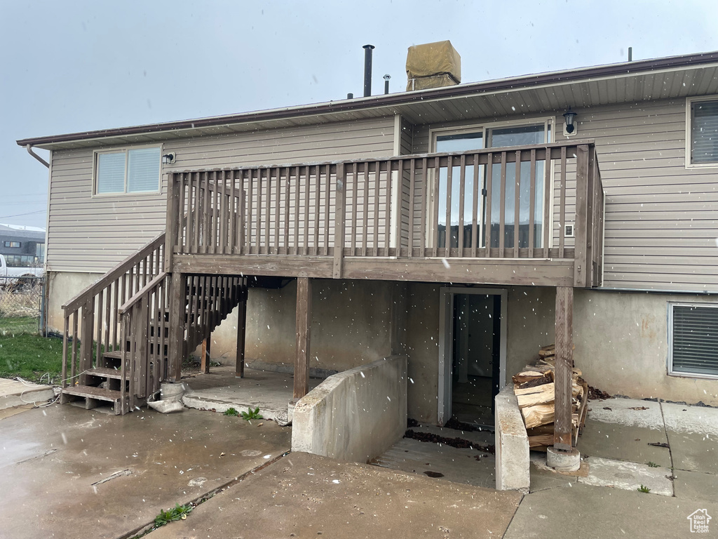 Rear view of property with a wooden deck and stairs