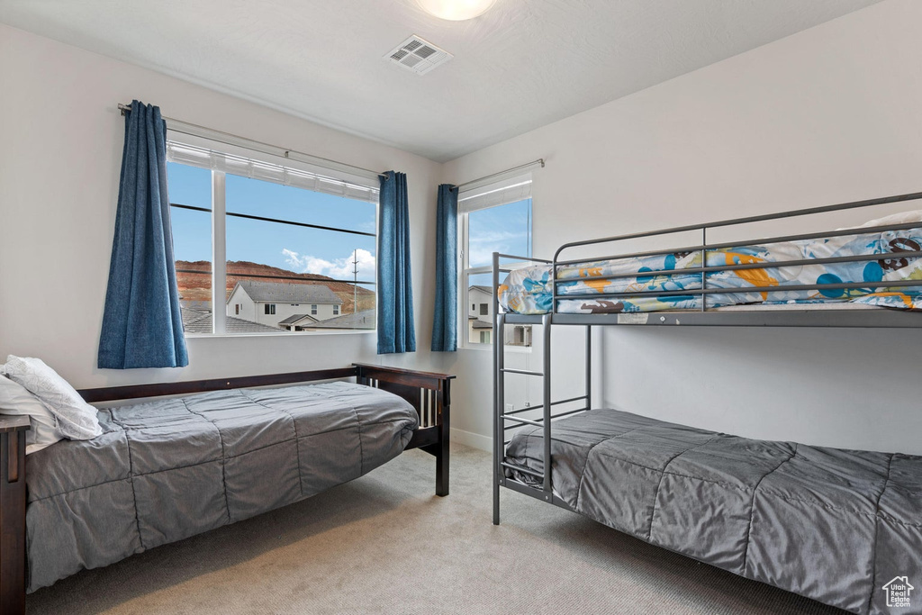 Carpeted bedroom with visible vents