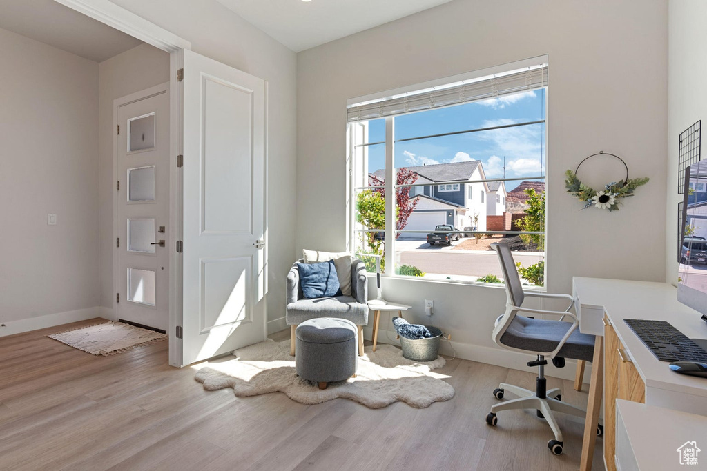 Office space featuring baseboards and wood finished floors