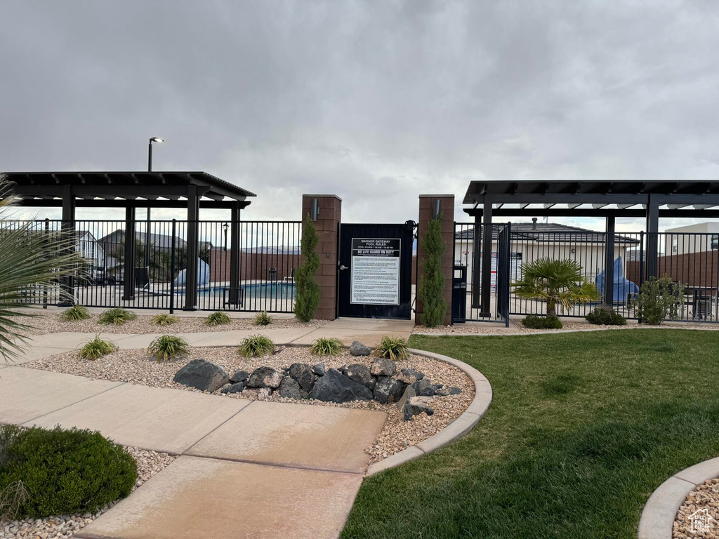 View of property's community featuring a yard, a gate, and fence