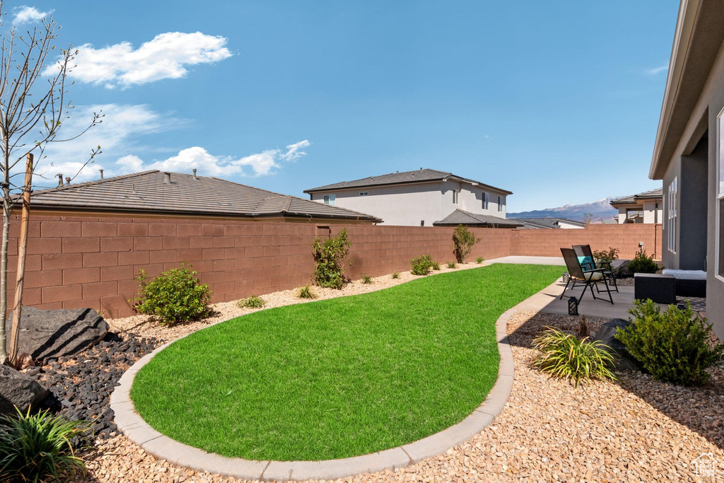 View of yard with a fenced backyard and a patio area