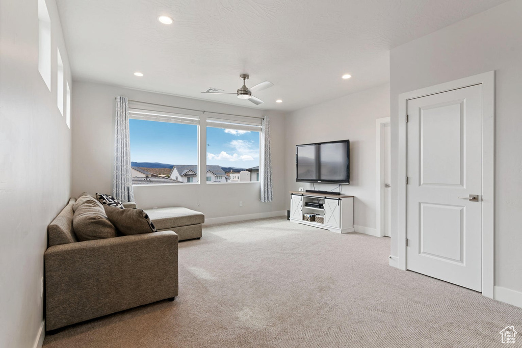 Living area featuring carpet flooring, recessed lighting, baseboards, and ceiling fan