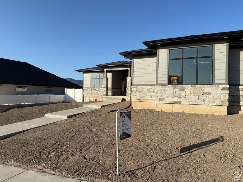 View of side of property with stone siding