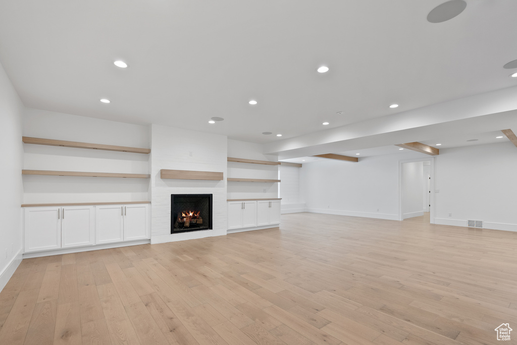 Unfurnished living room with recessed lighting, baseboards, light wood finished floors, and visible vents