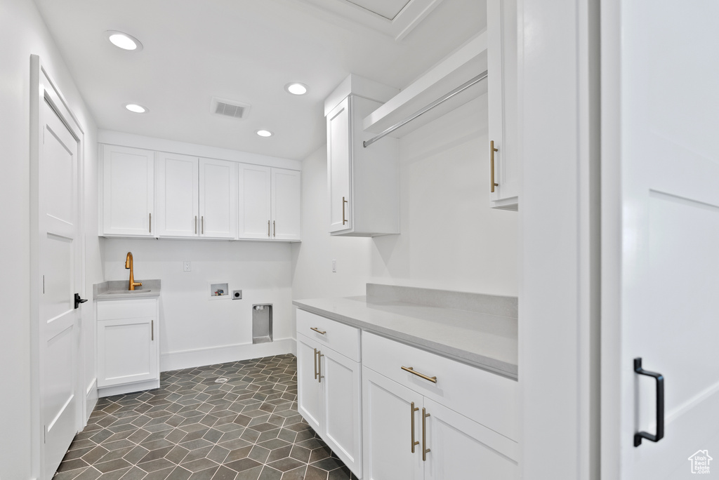 Laundry area with a sink, hookup for a washing machine, recessed lighting, hookup for an electric dryer, and visible vents