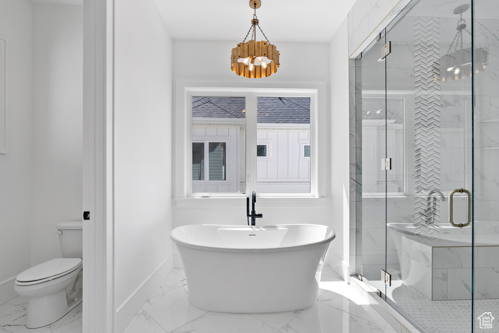 Bathroom featuring a shower stall, a notable chandelier, baseboards, toilet, and marble finish floor