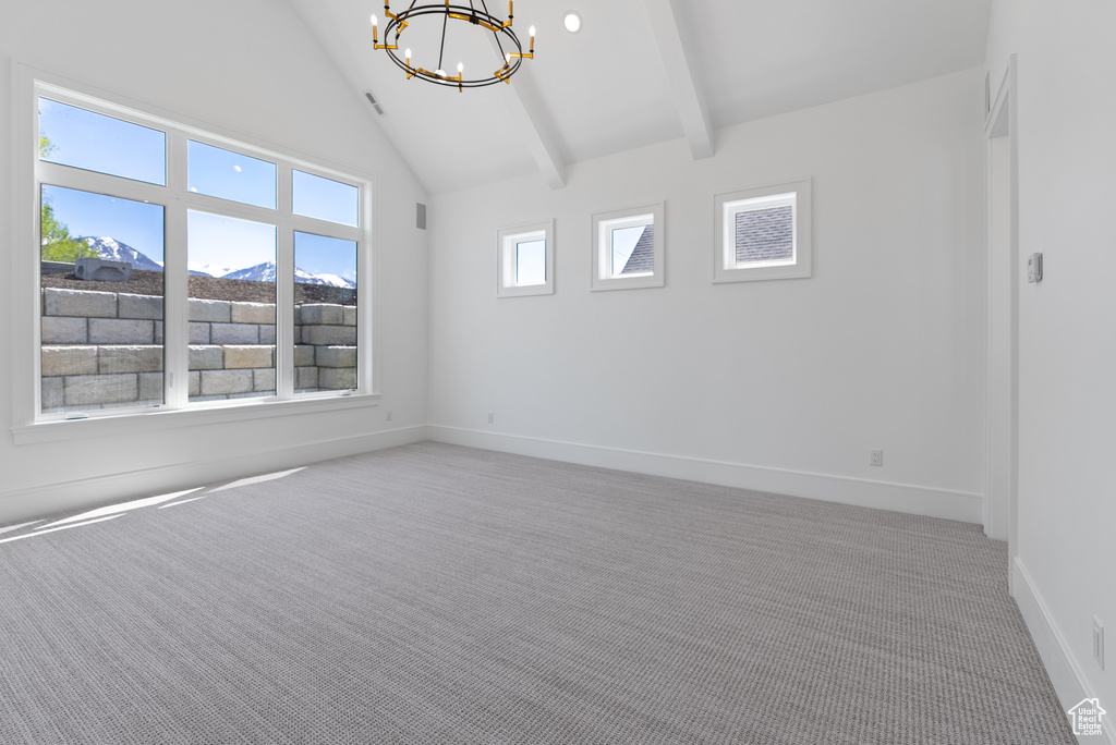 Carpeted empty room with an inviting chandelier, baseboards, high vaulted ceiling, and beamed ceiling