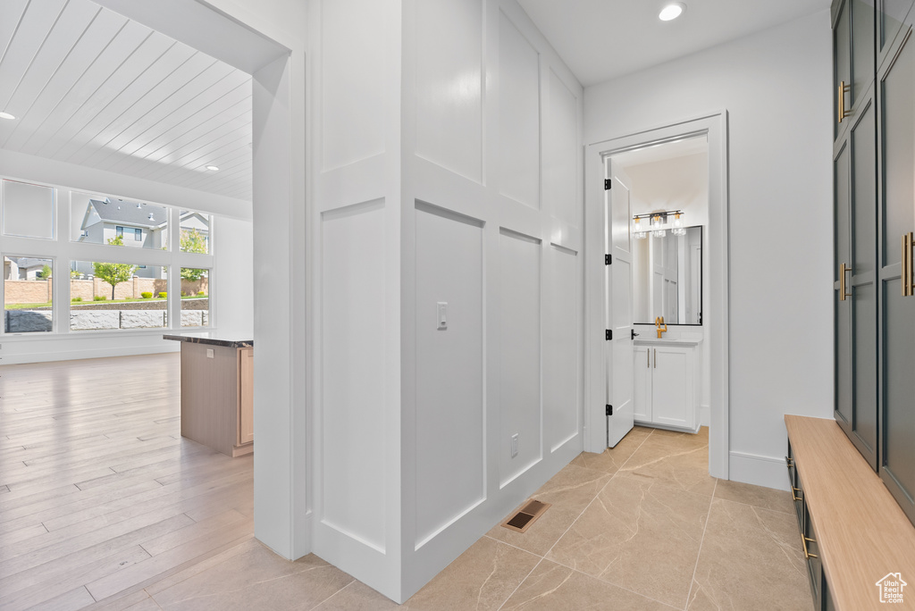 Hallway with recessed lighting and visible vents