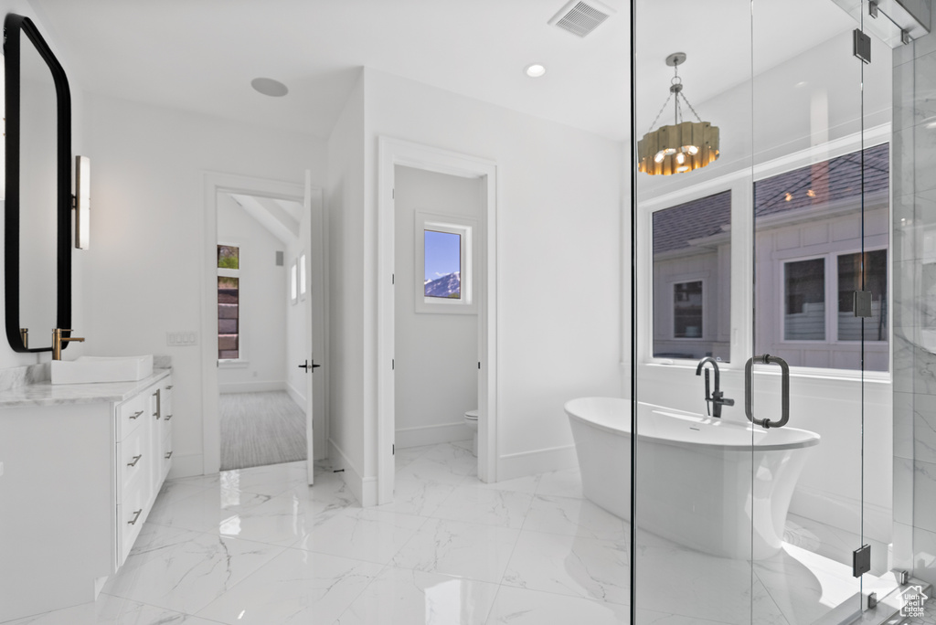 Full bath with a stall shower, visible vents, marble finish floor, and vanity