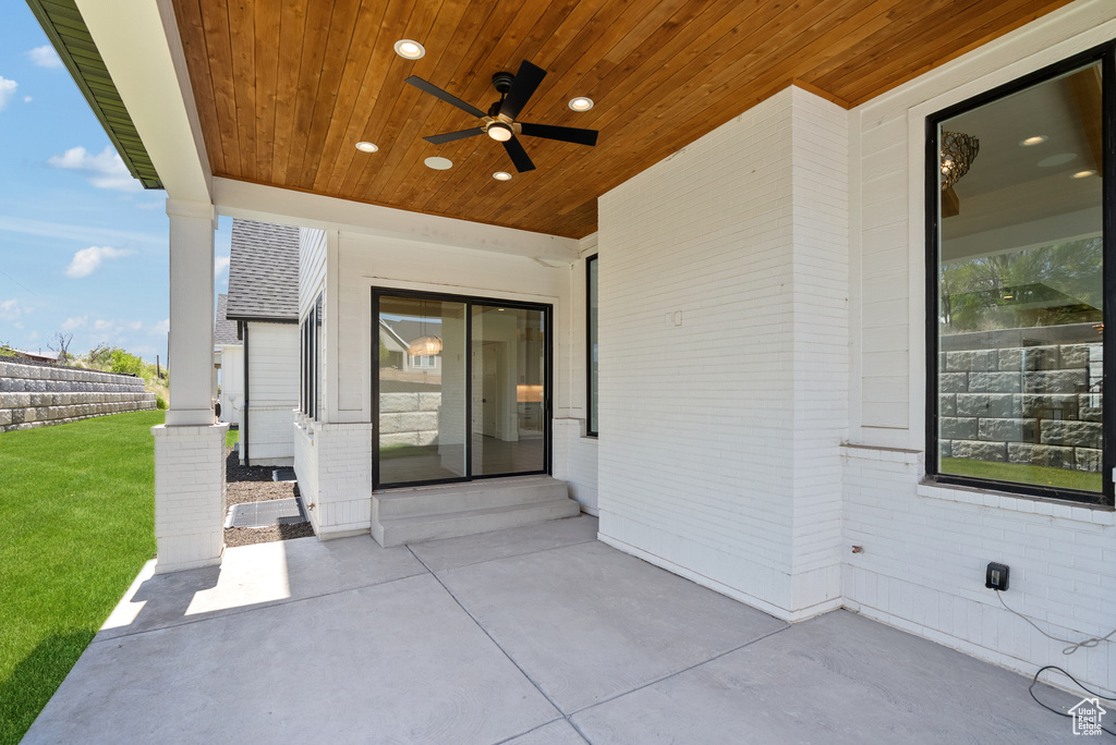 View of patio featuring ceiling fan and fence