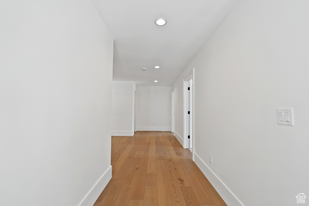 Corridor featuring recessed lighting, baseboards, and light wood-type flooring