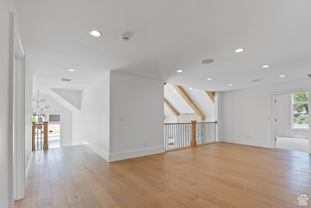 Unfurnished living room featuring baseboards, light wood-type flooring, recessed lighting, and visible vents
