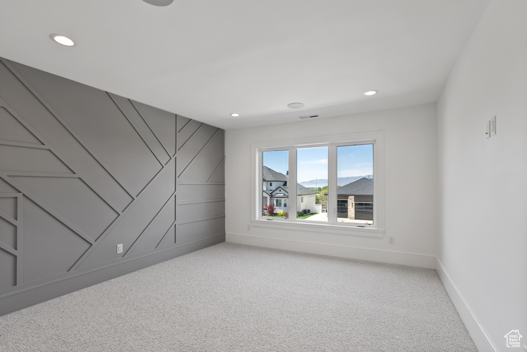 Empty room with recessed lighting, baseboards, and light colored carpet