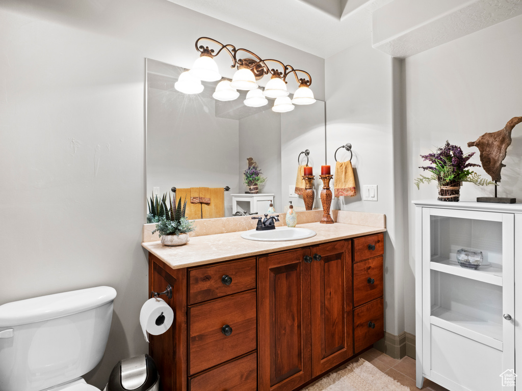 Bathroom with tile patterned flooring, vanity, and toilet