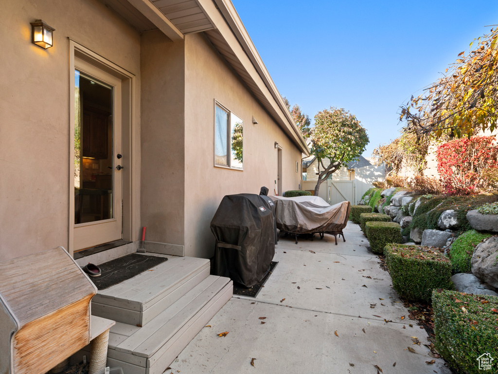 View of patio featuring a grill and fence