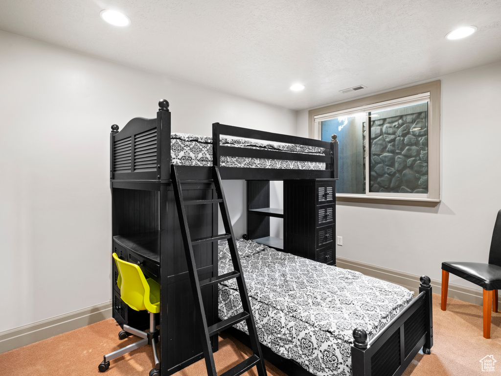 Bedroom with carpet floors, baseboards, recessed lighting, and visible vents