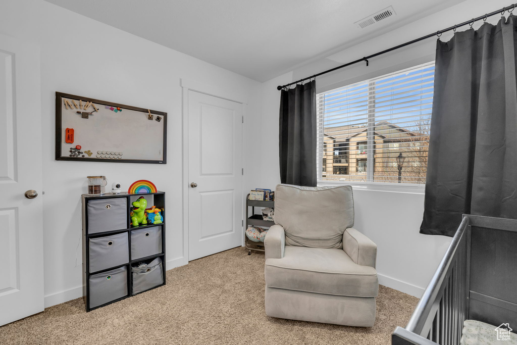 Bedroom featuring light carpet, baseboards, and visible vents