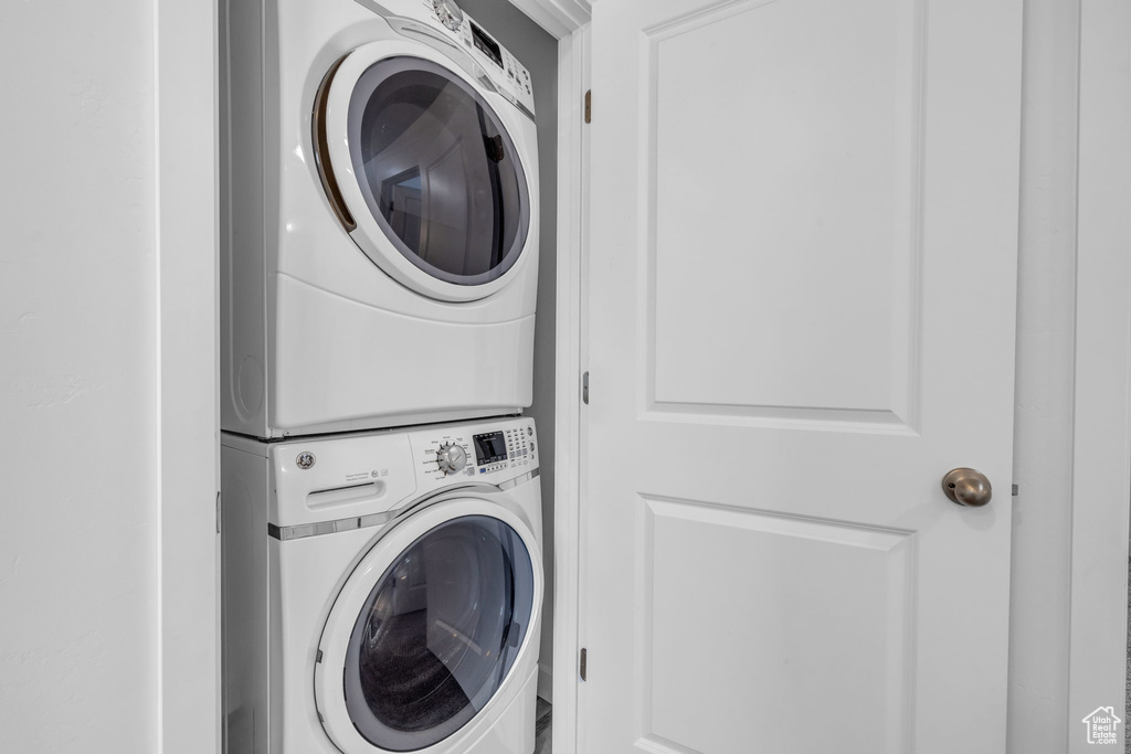 Washroom with stacked washer / dryer and laundry area