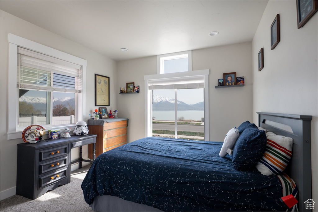 Carpeted bedroom featuring a water and mountain view