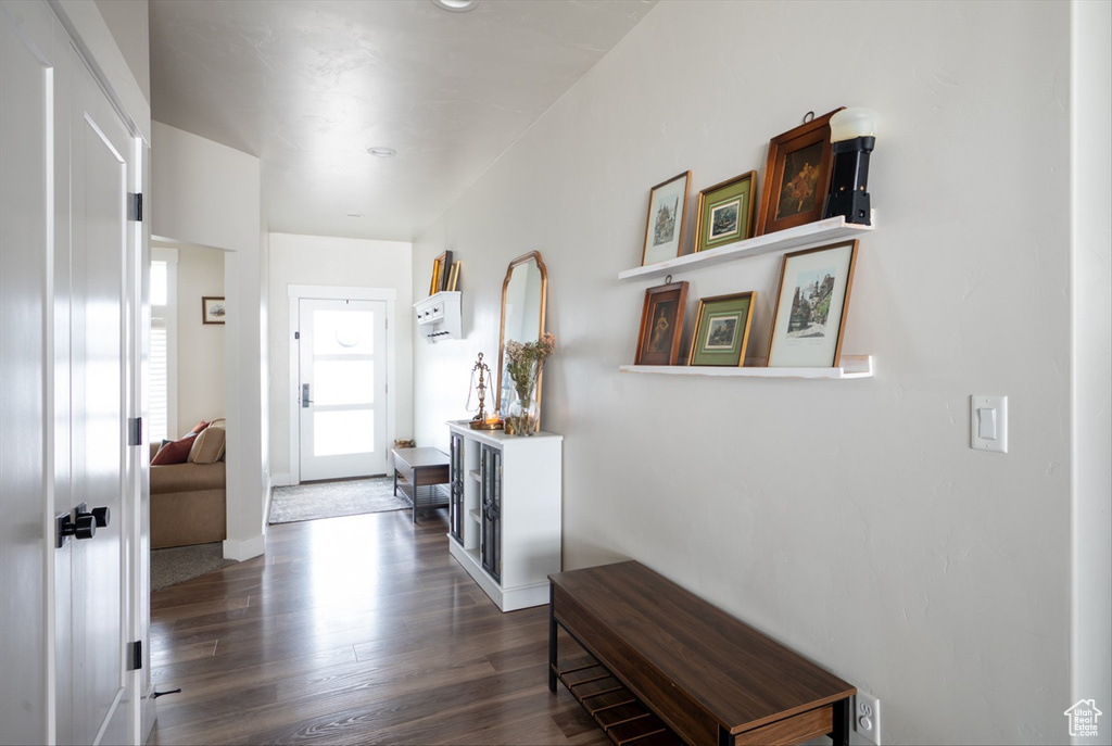 Foyer featuring baseboards and wood finished floors