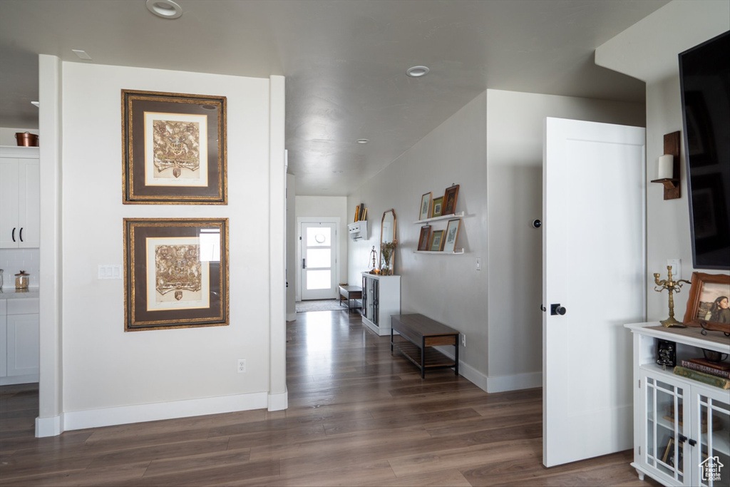 Hall with recessed lighting, dark wood-type flooring, and baseboards