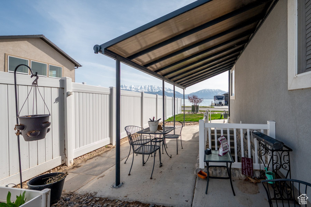 View of patio / terrace with a mountain view and fence