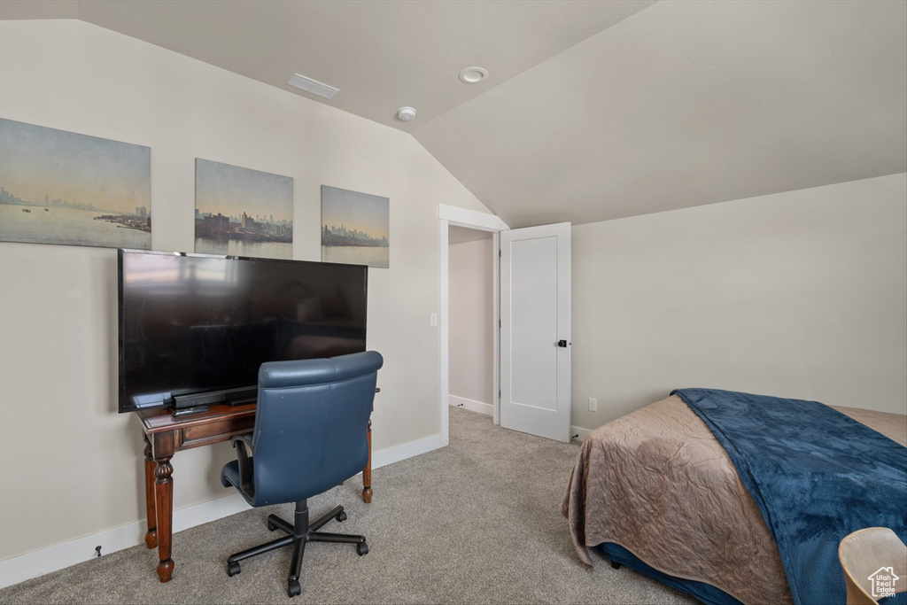 Bedroom with visible vents, baseboards, carpet, and vaulted ceiling