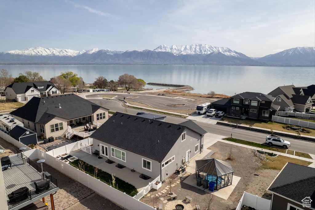 Birds eye view of property with a water and mountain view and a residential view
